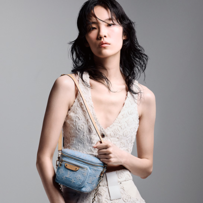 A summery Louis Vuitton Mini Bumbag in vintage-look sky blue Monogram denim, featuring a bleached and stonewashed finish, gold-tone hardware, a front pocket with an embossed leather label, and versatile removable chain and adjustable strap options.